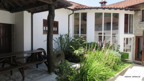 a patio with a bench and some plants at Casa do Contador T3 / T6 in Vieira do Minho
