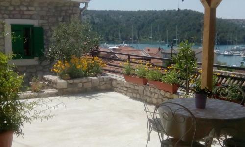 a patio with a table and some plants at Holiday Home Anna in Skradin