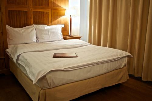 a bedroom with a large bed with white sheets and pillows at Rembrandt Old Town in Bucharest