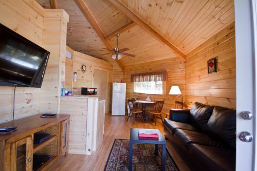 a living room with a couch and a table at Country Road Cabins in Hico