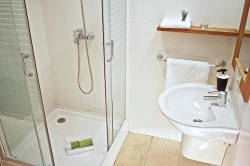 a bathroom with a shower and a toilet and a sink at Rembrandt Old Town in Bucharest