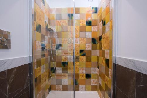 a bathroom with a shower with colorful tiles at La Bambagina in Amalfi