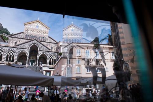 a large building with people walking in front of it at La Bambagina in Amalfi