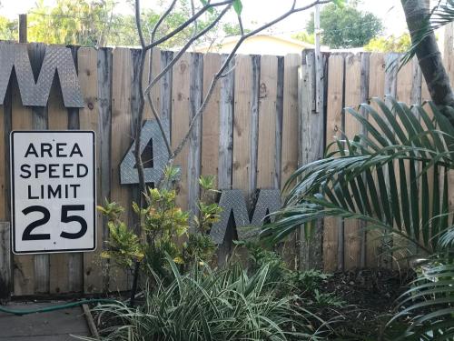 a speed limit sign in front of a fence at INN LEATHER GUEST HOUSE-GAY MALE ONLY in Fort Lauderdale