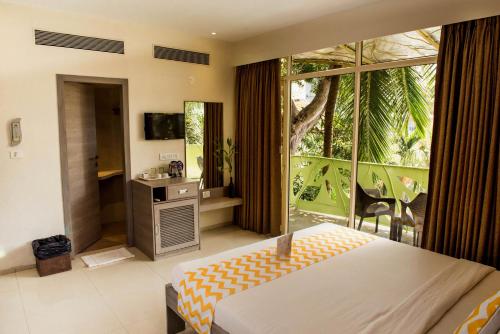 Ένα ή περισσότερα κρεβάτια σε δωμάτιο στο Sharanam Green Resort