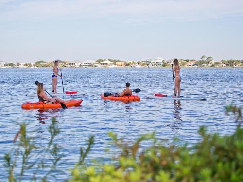 a group of people on kayaks in the water at Surf & Sand Hotel in Pensacola Beach