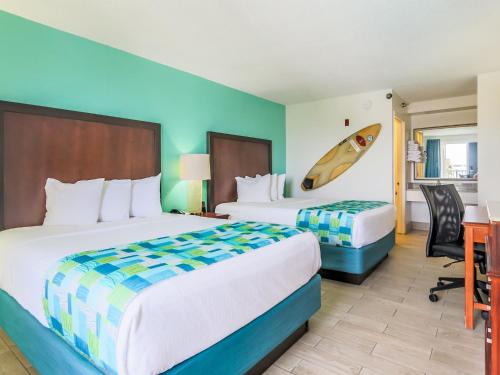 a hotel room with a bed and a desk at Surf & Sand Hotel in Pensacola Beach