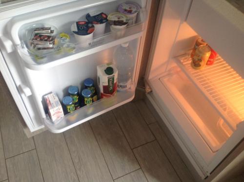 an open refrigerator filled with food and drinks at Residence Campagnole in Vicolungo