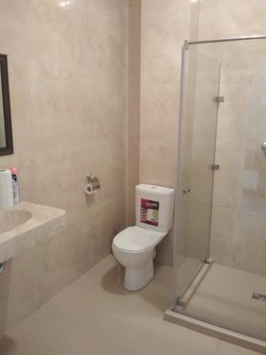 a bathroom with a toilet and a glass shower at Hotel Elita in Odesa