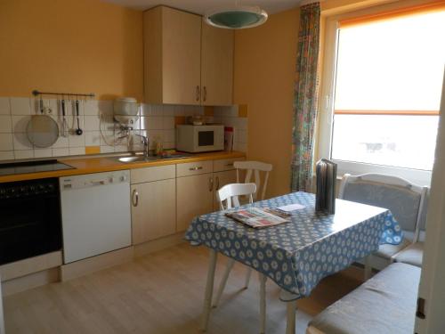 a kitchen with a table and a table and a window at Ferienwohnung Oppermann in Arholzen