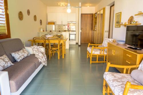 a living room with a couch and a table at Blue Wood Apartment in Letojanni