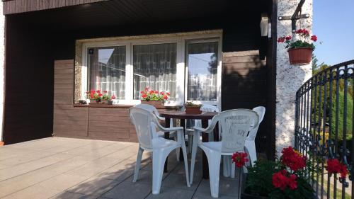 a patio with two chairs and a table and a window at Privát 347 in Broumov