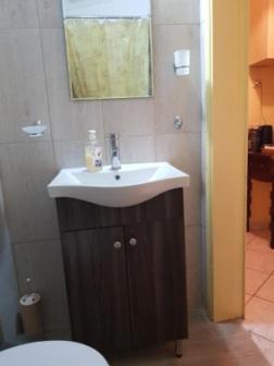 a bathroom with a sink and a toilet at Captains house in Poros