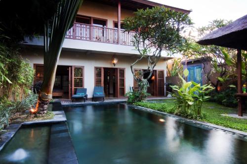a swimming pool in the backyard of a house at Ajanta Villa in Sanur