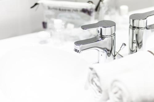 a close up of two sinks in a bathroom at Atao Residence- Rennes Sud in Vern-sur-Seiche