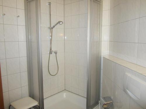 a shower with a glass door in a bathroom at Gästehaus am Ahr-Radweg in Antweiler