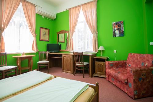 a green bedroom with a bed and a desk and chair at Art Studios Elsor in Burgas