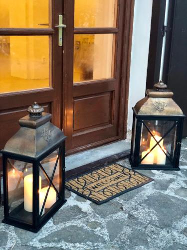 two lanterns sitting in front of a door at The Houses of History - anno 1830 in Tihany