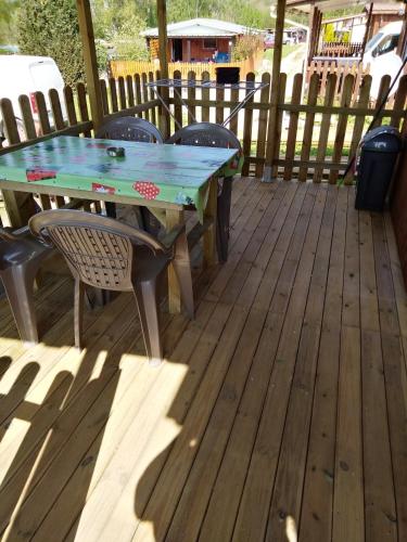 a table and chairs on a wooden deck at eurl de l'écluse in Inor