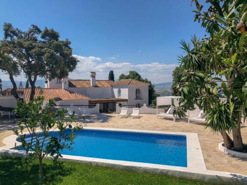 a swimming pool in front of a villa at B&B Casa Luz del Sur, adults only in Alhaurín el Grande