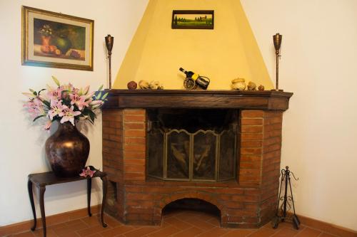 a brick fireplace with stuffed animals on top of it at Agriturismo Borgo Il Bonagino in Radda in Chianti