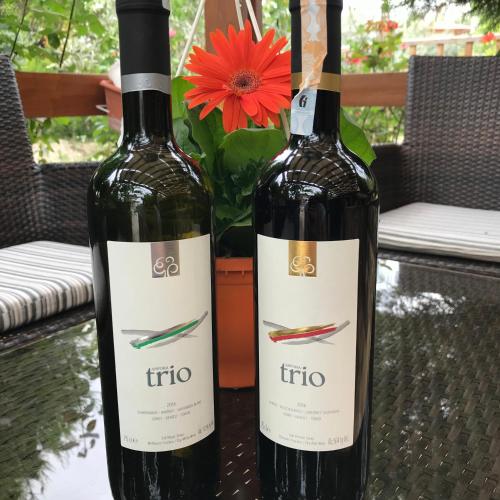 two bottles of wine sitting on a table with a flower at Melrose House Hotel in Pamukkale