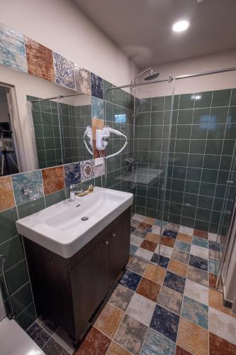 a bathroom with a sink and a shower at Vila Misko Natos in Dovainonys III