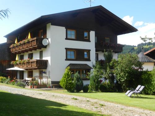 a white house with a black roof at Haus Baumgartner in Schattwald