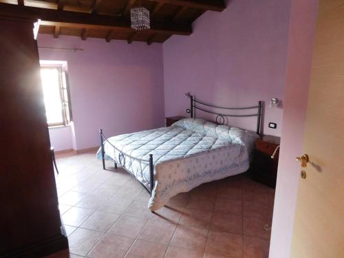 a bedroom with a bed in a room with purple walls at Casa Cristina in Milis