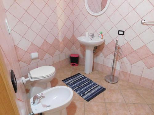 a bathroom with a toilet and a sink at Casa Cristina in Milis