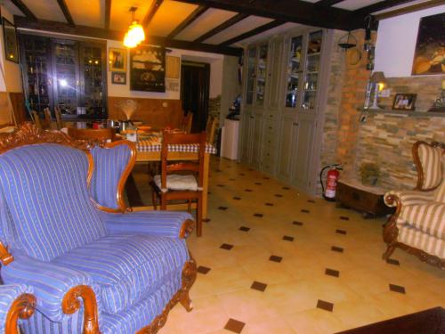 a living room with a couch and chairs and a table at Casa Rural Casa Pipo in Colunga