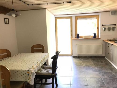 a dining room with a table and chairs and a window at Agroturystyka Zacisze in Maciejowiec