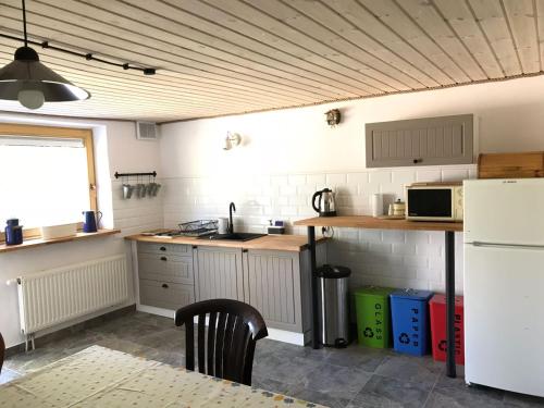 a kitchen with a sink and a stove top oven at Agroturystyka Zacisze in Maciejowiec