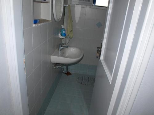 a small bathroom with a sink and a mirror at Alatsaria House in Cherronisos