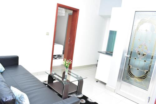 a living room with a couch and a mirror at Lebanon Hotel in Kigali