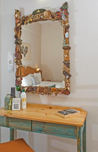 a bedroom with a bed and a mirror on a table at Arodamos Studios & Apts in Kissamos