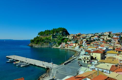 a view of a town with a harbor and the ocean at Acrothea Hotel in Parga