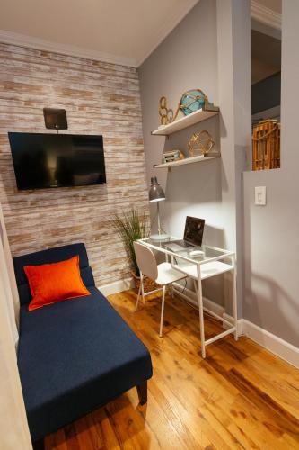 a living room with a couch and a desk with a laptop at Broadlind Hotel in Long Beach