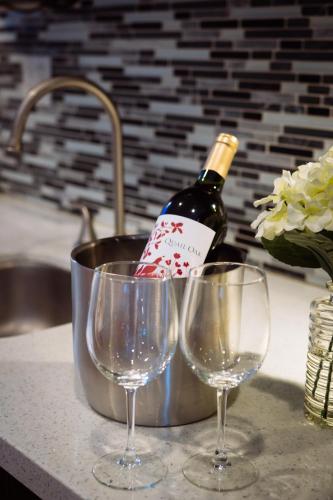 a bottle of wine and two wine glasses on a counter at Broadlind Hotel in Long Beach