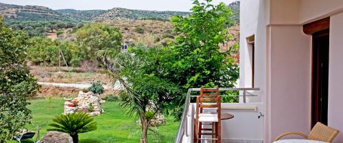 a balcony with a view of a garden at Arodamos Studios & Apts in Kissamos