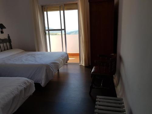 Postel nebo postele na pokoji v ubytování Hotel Lanjaron