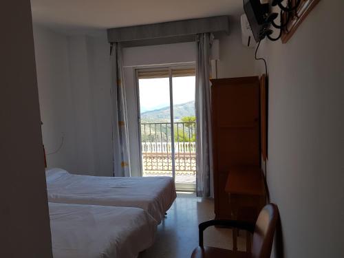 Postel nebo postele na pokoji v ubytování Hotel Lanjaron