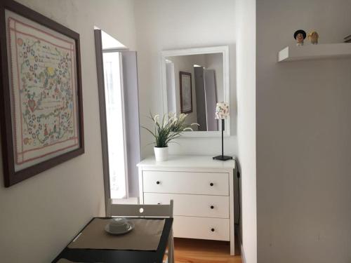 a living room with a dresser and a mirror at Cantinho da Matriz in Viana do Castelo