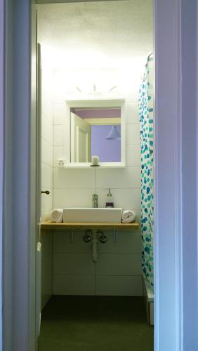 a bathroom with a sink and a mirror at Adventure Hostel Interlaken in Interlaken