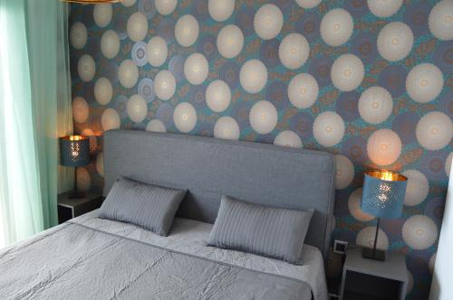 a bedroom with a bed and a wall with balls at Sunset Drive Exclusive - Benidorm in Benidorm