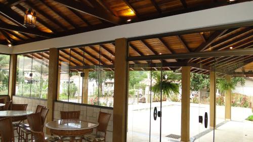 a patio with tables and chairs and windows at Flats Martinez in Conservatória