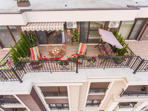 an aerial view of a balcony with chairs and flowers at Sky Garden Apartment Burgas in Burgas