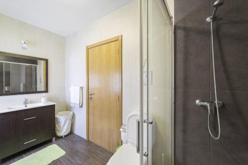 a bathroom with a shower and a toilet and a sink at Casa do Porto Carreiro in Oliveira de Azemeis