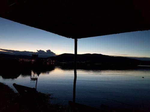 a view of a body of water with the sunset at Uros Lake Titicaca Lodge in Puno