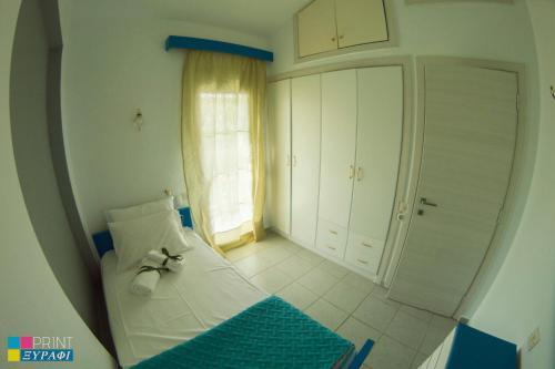a bedroom with a bed with a bow on it at The L Villa in Nea Peramos
